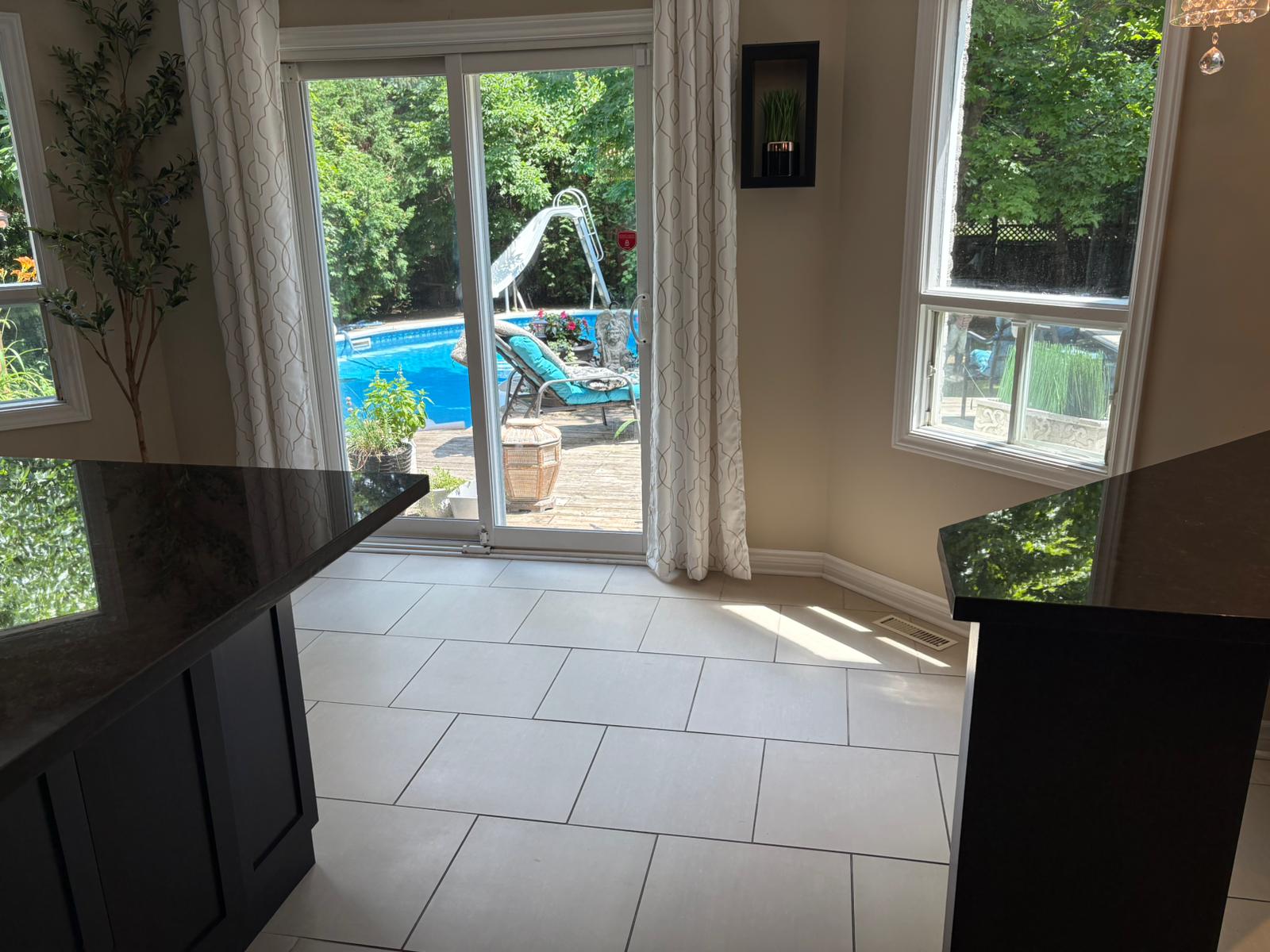 Bright kitchen with pool view after professional clean